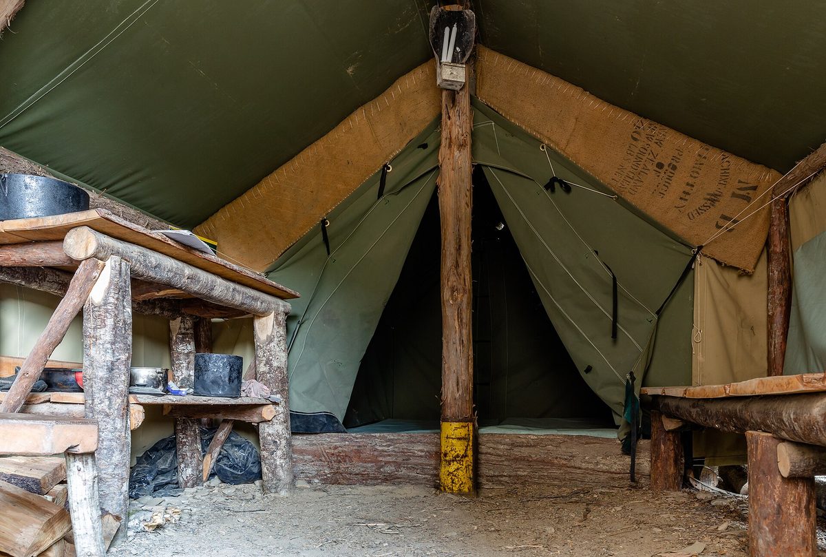 The inside of a pitched tent showing the sleeping area and frame.